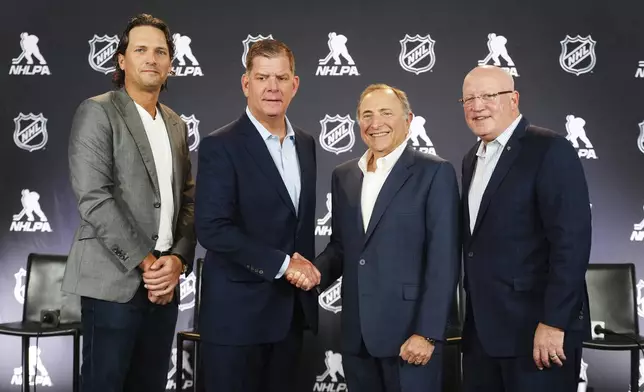 From left to right, Ron Hainsey, NHLPA Assistant Executive Director, Marty Walsh, NHLPA Executive Director, Gary Bettman, NHL Commissioner, and Bill Daly, NHL Deputy Commissioner, pose for photos after a joint press conference before the NHL hockey draft Friday, June 27, 2025, in Los Angeles. (AP Photo/Damian Dovarganes)
