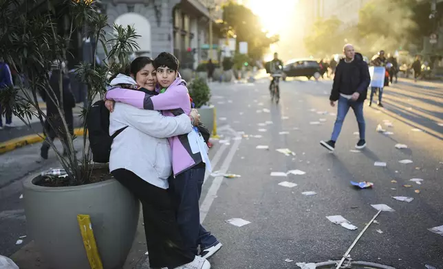 Supporters of Argentina's former President Cristina Fernandez embrace at the end of a protest in her defense after she began serving a six-year prison sentence under house arrest for corruption, in Buenos Aires, Argentina, Wednesday, June 18, 2025. (AP Photo/Rodrigo Abd)