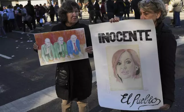 A supporter of Argentina's former President Cristina Fernandez holds a sign that reads in Spanish "Innocent" during protest in her defense after she began serving a six-year prison sentence under house arrest for corruption, in Buenos Aires, Argentina, Wednesday, June 18, 2025. (AP Photo/Rodrigo Abd)
