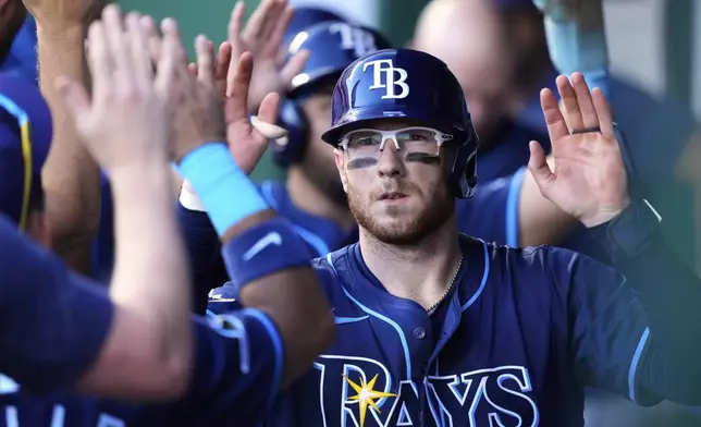 Tampa Bay Rays' Danny Jansen celebrates in the dugout after hitting a Sacrifice fly to score a run during the fourth inning of a baseball game against the Kansas City Royals, Tuesday, June 24, 2025, in Kansas City, Mo. (AP Photo/Charlie Riedel)