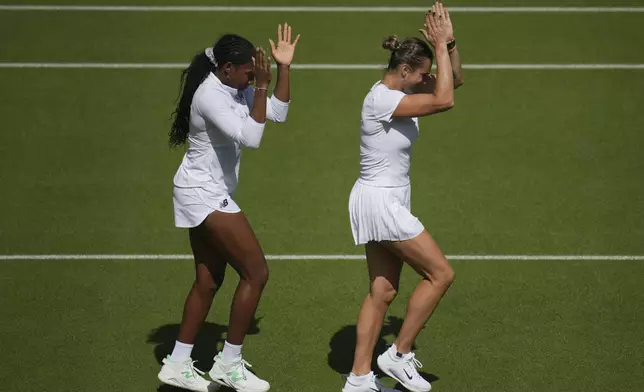 Aryna Sabalenka of Belarus, right, and Coco Gauff of United States during a practice session ahead of the Wimbledon Championships in London, Friday, June 27, 2025. (AP Photo/Kin Cheung)