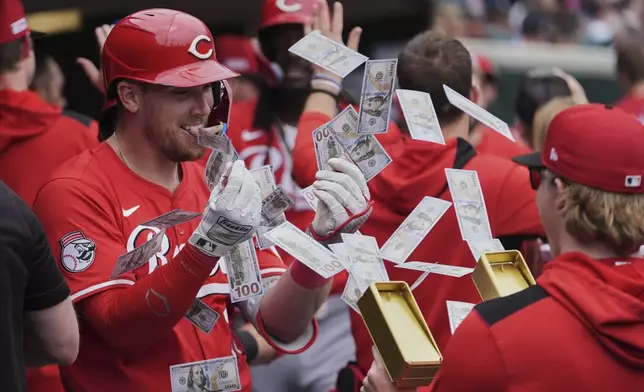 Cincinnati Reds' Tyler Stephenson, left, celebrates his grand slam against the Detroit Tigers in the fifth inning during a baseball game, Saturday, June 14, 2025, in Detroit. (AP Photo/Paul Sancya)