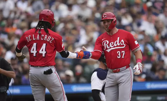 Cincinnati Reds' Tyler Stephenson (37)celebrates his grand slam with Elly De La Cruz (44) against the Detroit Tigers in the fifth inning during a baseball game, Saturday, June 14, 2025, in Detroit. (AP Photo/Paul Sancya)