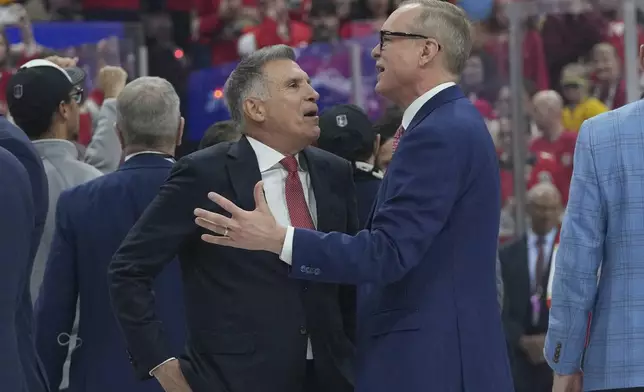 Vincent Viola, owner of the Florida Panthers, left, speaks to head coach Paul Maurice after the team defeated the Edmonton Oilers in Game 6 of the NHL hockey Stanley Cup Final Tuesday, June 17, 2025, in Sunrise, Fla. (AP Photo/Lynne Sladky)