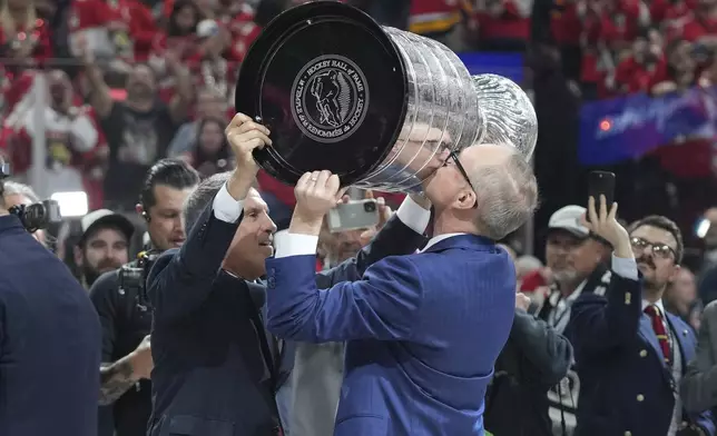 Florida Panthers head coach Paul Maurice kisses the Stanley Cup trophy after defeating the Edmonton Oilers in Game 6 of the NHL hockey Stanley Cup Final Tuesday, June 17, 2025, in Sunrise, Fla. (AP Photo/Lynne Sladky)