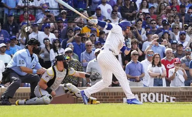 Chicago Cubs' Ian Happ, right, hits a walkoff single against the Pittsburgh Pirates during the 10th inning of a baseball game Sunday, June 15, 2025, in Chicago. (AP Photo/David Banks)
