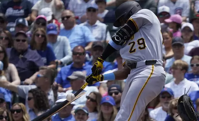 Pittsburgh Pirates' Alexander Canario hits a one-run groundout against the Chicago Cubs during the first inning of a baseball game Sunday, June 15, 2025, in Chicago. (AP Photo/David Banks)