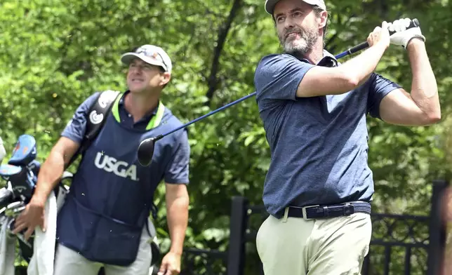 Mark Hensby, right, hits off of the tee on the 18th hole during the first session of the first day at the U.S. Senior Open Championship at Broadmoor Golf Club in Colorado Springs, Colo., Thursday, June 26, 2025. (Jerilee Bennett/The Gazette via AP)