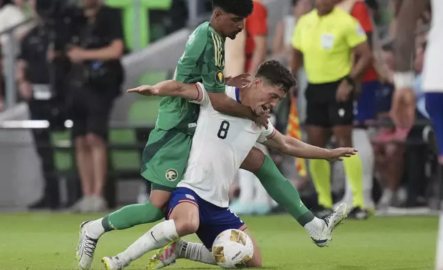 United States' Sebastian Berhalter (8) is grabbed by Saudi Arabia's Ziyad Aljohani, left, during a CONCACAF Gold Cup soccer match, Thursday, June 19, 2025, in Austin, Texas. (AP Photo/Eric Gay)