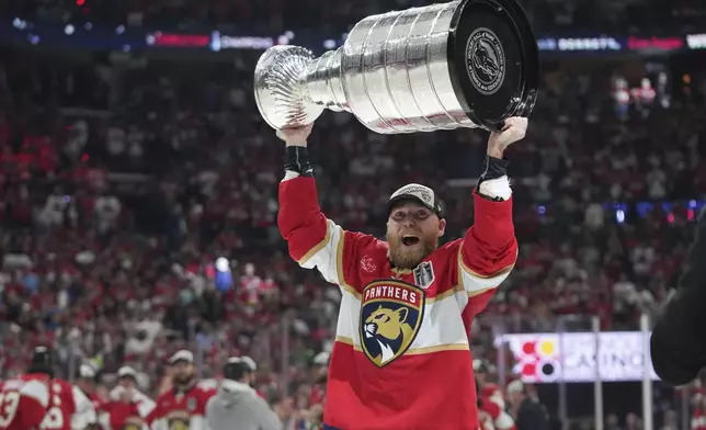 Florida Panthers center Sam Bennett lifts the Stanley Cup after defeating the Edmonton Oilers in Game 6 of the NHL hockey Stanley Cup Final Tuesday, June 17, 2025, in Sunrise, Fla. (AP Photo/Lynne Sladky)