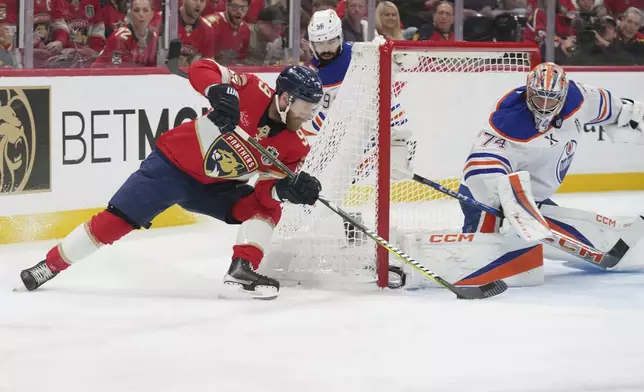 Edmonton Oilers goaltender Stuart Skinner (74) blocks a shot by Florida Panthers center Sam Bennett (9) during the second period of Game 6 of the NHL hockey Stanley Cup Final Tuesday, June 17, 2025, in Sunrise, Fla. (AP Photo/Lynne Sladky)