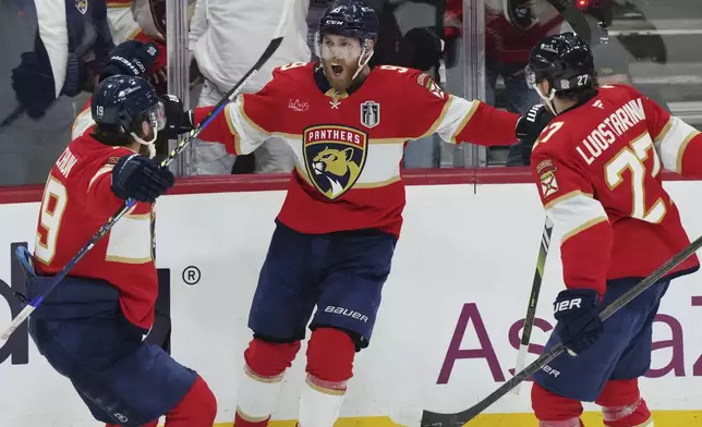 Florida Panthers' Sam Bennett (9) celebrates his goal against the Edmonton Oilers with Matthew Tkachuk (19) and Eetu Luostarinen (27) during the second period in Game 3 of the NHL hockey Stanley Cup finals in Sunrise, Fla., Monday, June 9, 2025. (Nathan Denette/The Canadian Press via AP)