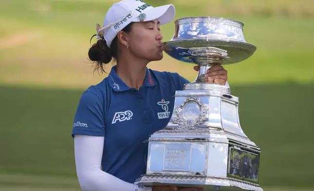 Minjee Lee kisses the trophy after winning the Women's PGA Championship golf tournament Sunday, June 22, 2025, in Frisco, Texas. (AP Photo/LM Otero)