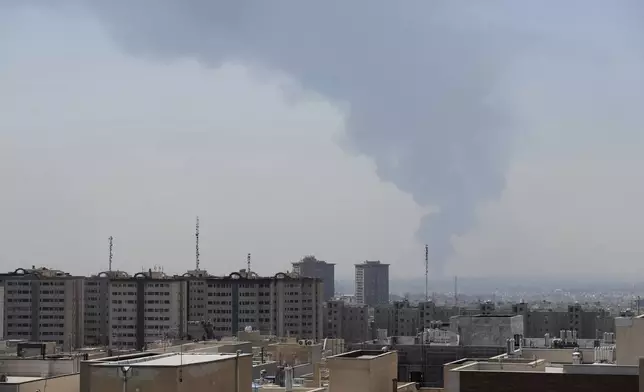 Huge smoke rises up from an oil facility after a Saturday explosion in southern Tehran, Iran, Sunday, June 15, 2025. (AP Photo/Vahid Salemi)