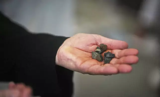 A Muslim pilgrim holds stones during the symbolic stoning of the devil, the last rite of the annual Hajj, in Mina near the holy city of Mecca, Saudi Arabia, Friday, June 6, 2025. (AP Photo/Amr Nabil)