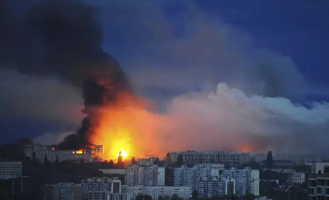 Fire and smoke rise from the site where a Russian missile struck a residential area in Kharkiv, Ukraine, Saturday, June 7, 2025, (AP Photo/Anatolii Lysianskyi)