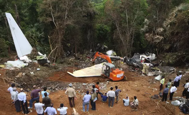 FILE - An earth remover cleans the site of the crash of an Air India Boeing 737-800 plane in Mangalore, in the southern Indian state of Karnataka, Monday, May 24, 2010. (AP Photo/Rafiq Maqbool, File)