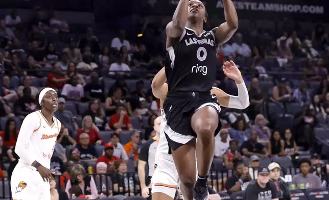 Las Vegas Aces guard Jackie Young (0) drives the basket during the first half of a WNBA basketball game against the Phoenix Mercury, Sunday, June 15, 2025, in Las Vegas. (Steve Marcus/Las Vegas Sun via AP)