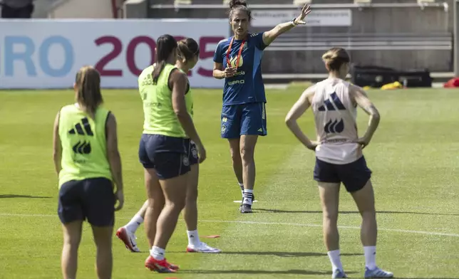 Spanish head coach Montserrat Tome Vazquez, rear center, gestures during the training session of the Spanish women's national football team in Lausanne, Switzerland, Monday, June 30, 2025, ahead of the UEFA Women's EURO 2025. (Cyril Zingaro/Keystone via AP)