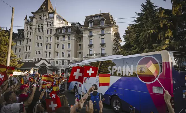 Fans react to the arrival of the Spain's women's national football team at their hotel, the Royal Savoy in Lausanne, Switzerland, on the sidelines of the UEFA Women's Euro 2025, Sunday, June 29, 2025. (Gabriel Monnet/Keystone via AP)