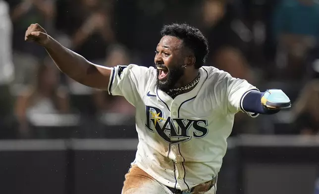 Tampa Bay Rays' Junior Caminero reacts after scoring the game-winning run on an RBI single by Taylor Walls off Texas Rangers pitcher Robert Garcia during the ninth inning of a baseball game Thursday, June 5, 2025, in Tampa, Fla. (AP Photo/Chris O'Meara)