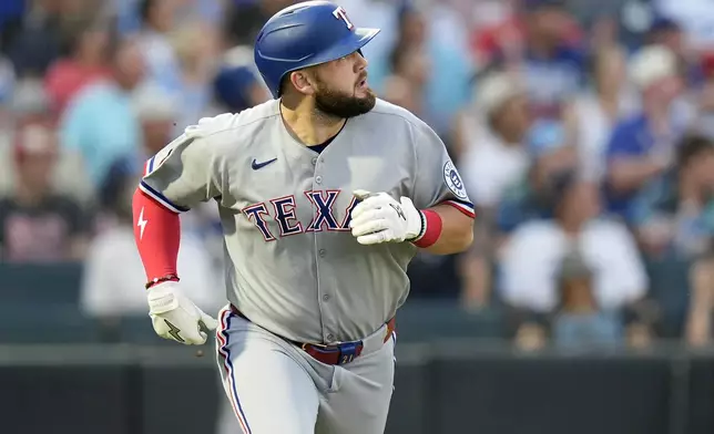 Texas Rangers' Jake Burger watches his home run off Tampa Bay Rays pitcher Ryan Pepiot during the third inning of a baseball game Thursday, June 5, 2025, in Tampa, Fla. (AP Photo/Chris O'Meara)