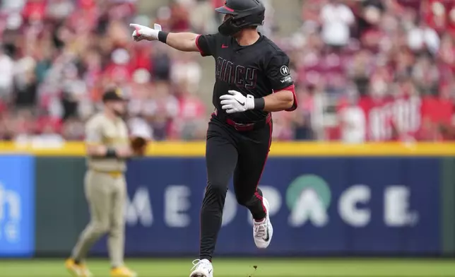 Cincinnati Reds' Spencer Steer gestures as he rounds the bases after hitting a solo home run during the second inning of a baseball game against the San Diego Padres, Friday, June 27, 2025, in Cincinnati. (AP Photo/Jeff Dean)