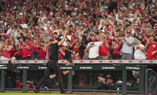 Cincinnati Reds pitcher Nick Martinez (28) gestures to the crowd after a pitching change during the ninth inning of a baseball game against the San Diego Padres, Friday, June 27, 2025, in Cincinnati. (AP Photo/Jeff Dean)