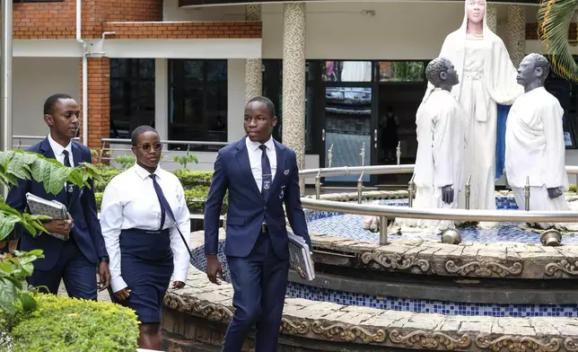 Students walk past the administration block at Uganda Martyrs' Secondary School Namugongo, in Kampala, Uganda Monday, May 26, 2025. (AP Photo/Hajarah Nalwadda)