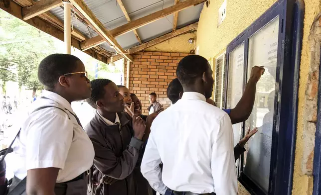 Students look on the notice board at Uganda Martyrs' Secondary School Namugongo, in Kampala, Uganda Monday, May 26, 2025. (AP Photo/Hajarah Nalwadda)