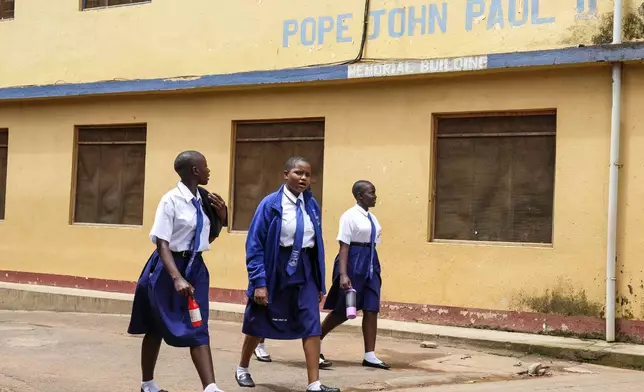Students walk around the school compound at Uganda Martyrs' Secondary School Namugongo, in Kampala, Uganda Monday, May 26, 2025. (AP Photo/Hajarah Nalwadda)