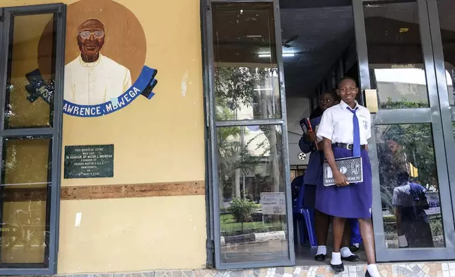 Students walk out of the dining hall at Uganda Martyrs' Secondary School Namugongo, in Kampala, Uganda Monday, May 26, 2025. (AP Photo/Hajarah Nalwadda)
