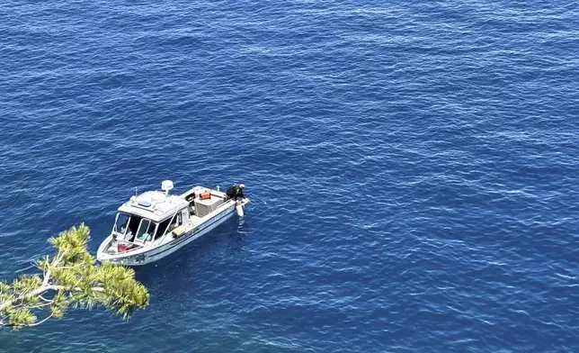 Authorities conduct searches along the shore at D.L. Bliss State Park after a weekend incident in which a boat capsized, killing several people, on Monday, June 23, 2025, in South Lake Tahoe, Calif. (AP Photo/Brooke Hess-Homeier)