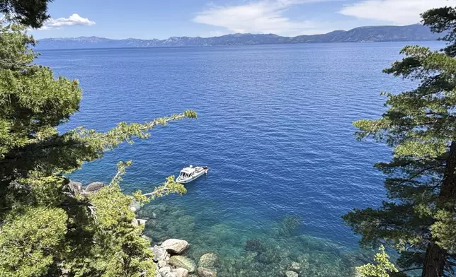 Authorities conduct searches along the shore at D.L. Bliss State Park after a weekend incident in which a boat capsized, killing several people, on Monday, June 23, 2025, in South Lake Tahoe, Calif. (AP Photo/Brooke Hess-Homeier)