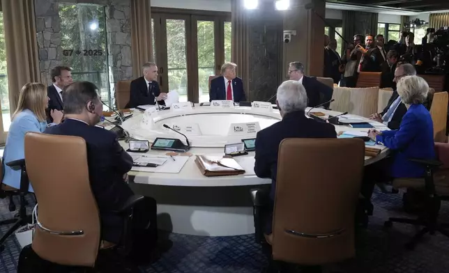Italy's Prime Minister Giorgia Meloni, from left, France's President Emmanuel Macron, Canada's Prime Minister Mark Carney, President Donald Trump, Britain's Prime Minister Keir Starmer and Germany's Chancellor Friedrich Merz participate in a session of the G7 Summit, Monday, June 16, 2025, in Kananaskis, Canada. (AP Photo/Mark Schiefelbein)