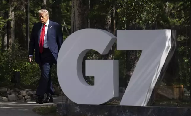 United States President Donald Trump makes his way to the official welcome at the G7 Summit in Kananaskis, Alberta, Canada, Monday, June 16, 2025. (Adrian Wyld/The Canadian Press via AP)
