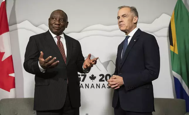 Canadian Prime Minister Mark Carney, right, meets with President of the Republic of South Africa Cyril Ramaphosa, left, as the G7 gets under way in Calgary, Alberta, Sunday, June 15, 2025. (Jason Franson/The Canadian Press via AP)