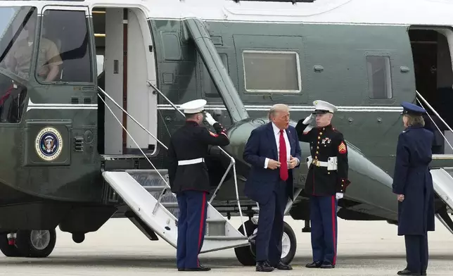 President Donald Trump, second left, is saluted by escort by Air Force Col. Angela F. Ochoa, Commander, 89th Airlift Wing, right, before walking from Marine One to board Air Force One, Sunday, June 15, 2025, at Joint Base Andrews, Md., for a trip to Canada to attend the G7 Summit.(AP Photo/Jacquelyn Martin)