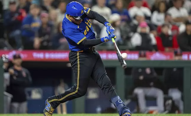 Seattle Mariners' Jorge Polanco hits a solo home run during the eighth inning of a baseball game against the Cleveland Guardians, Friday, June 13, 2025, in Seattle. (AP Photo/Stephen Brashear)