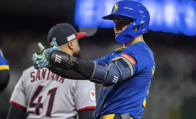 Seattle Mariners' Ben Williamson celebrates at first base after hitting a single during the seventh inning of a baseball game against the Cleveland Guardians, Friday, June 13, 2025, in Seattle. (AP Photo/Stephen Brashear)