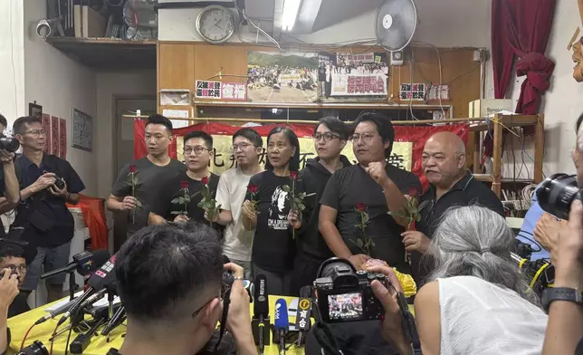 Current and former members of Hong Kong's pro-democracy political party, the League of Social Democrats, speak at a press conference, in Hong Kong, Sunday, June 29, 2025. (AP Photo/Kanis Leung)