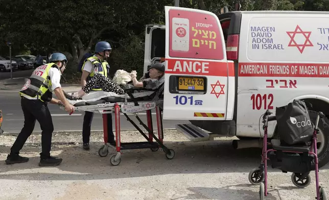 Medics evacuate a woman injured in an Iranian missile strike in Tel Aviv, Israel, Sunday, June 22, 2025. (AP Photo/Bernat Armangue)