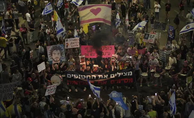 People take part in a protest demanding the end of the war and immediate release of hostages held by Hamas in the Gaza Strip, and against Prime Minister Benjamin Netanyahu's government in Tel Aviv, Israel, Saturday, June 7, 2025. (AP Photo/Ohad Zwigenberg)