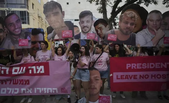Relatives and supporters of Israeli hostages held by Hamas in Gaza display photos of the captives during a protest demanding their release. in Tel Aviv, Israel, on Saturday, June 21, 2025. (AP Photo/Ohad Zwigenberg)