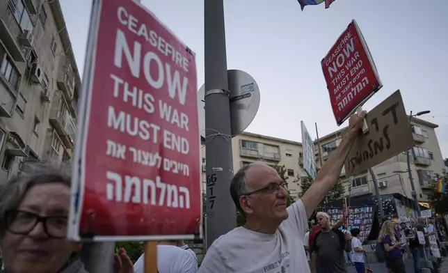 Israelis take part in a protest demanding the immediate release of hostages held by Hamas in the Gaza Strip and end of the war with Hamas and Iran, in Haifa, Israel, Saturday, June 21, 2025. (AP Photo/Baz Ratner)