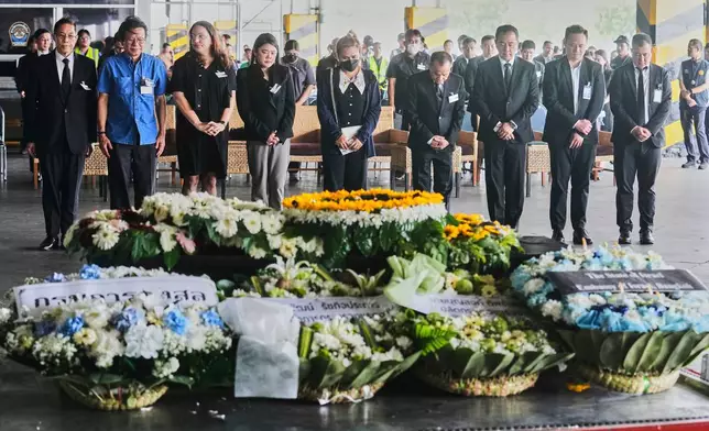 Narissara Chantasang, fifth from left, wife of Nattapong Pinta, a Thai laborer who was taken hostage by Hamas attends a silent memorial service near a coffin containing his body at Suvarnabhumi International Airport in Samut Prakarn province Thailand, Wednesday, June 11, 2025. (AP Photo/Sakchai Lalit)