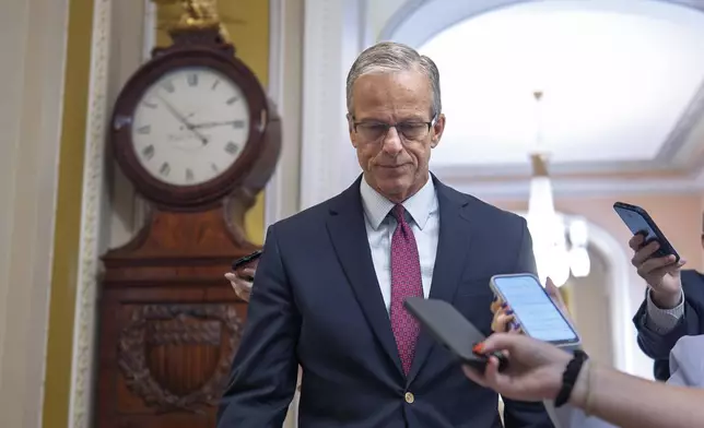 Senate Majority Leader John Thune, R-S.D., walks to the chamber as Senate Republicans work to pass President Donald Trump's bill of tax breaks and spending cuts by his July Fourth deadline, at the Capitol in Washington, Sunday, June 29, 2025. (AP Photo/J. Scott Applewhite)