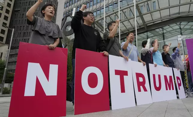 Members of civic groups stage a rally against U.S. President Donald Trump's tariffs policy in Seoul, South Korea, Monday, June 30, 2025. (AP Photo/Ahn Young-joon)