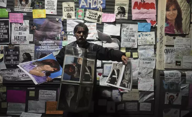 A vendor hawks pictures of former President Cristina Fernandez outside her home, after a federal court granted her request to serve a six-year prison sentence for corruption at her home, in Buenos Aires, Argentina, Tuesday, June 17, 2025. (AP Photo/Natacha Pisarenko)