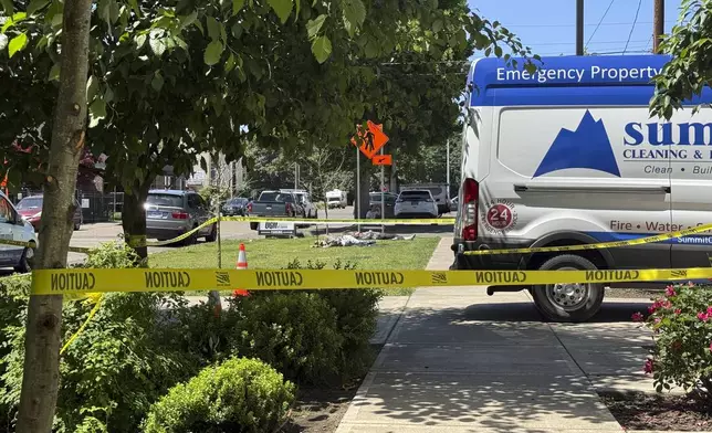 Police tape cordons off an area outside the Union Gospel Mission homeless shelter in Salem, Ore., Monday, June 2, 2025. (AP Photo/Claire Rush)
